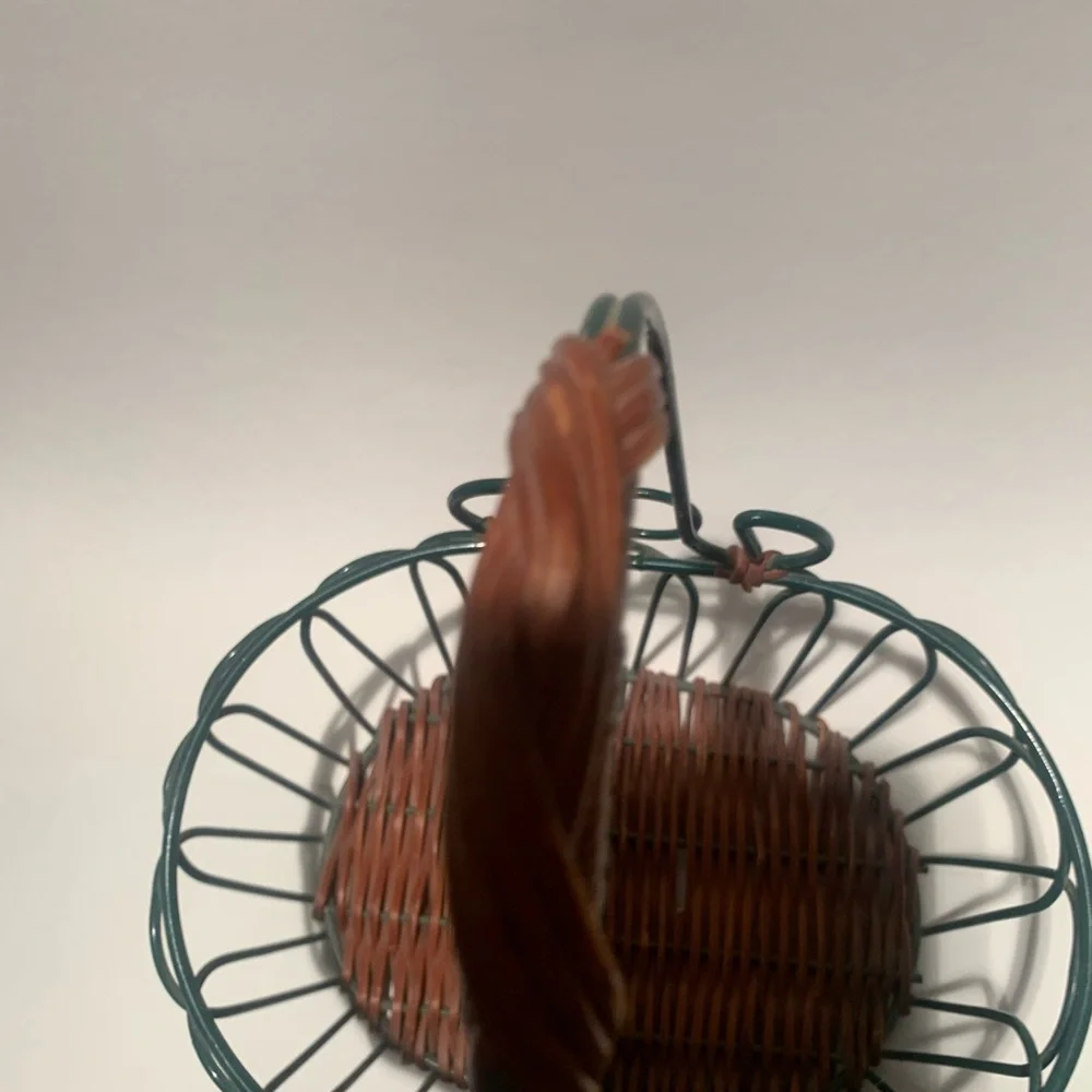 Green wire basket with brown woven bottom